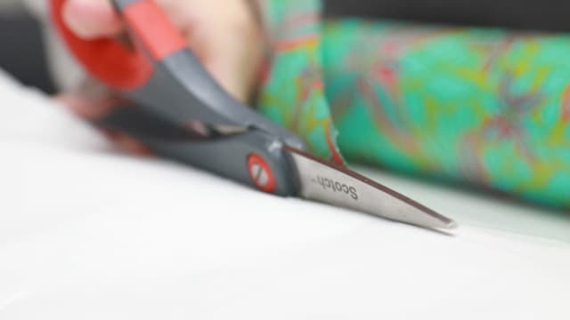 Cutting gift wrap away from the roll