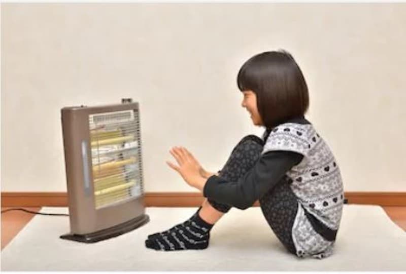 Girl in front of space heater