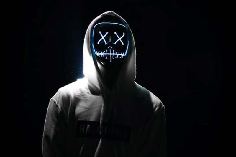 person in hoodie wearing led purge mask