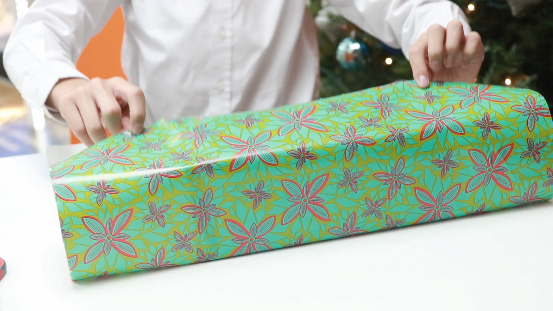 Taping wrapping paper to the box