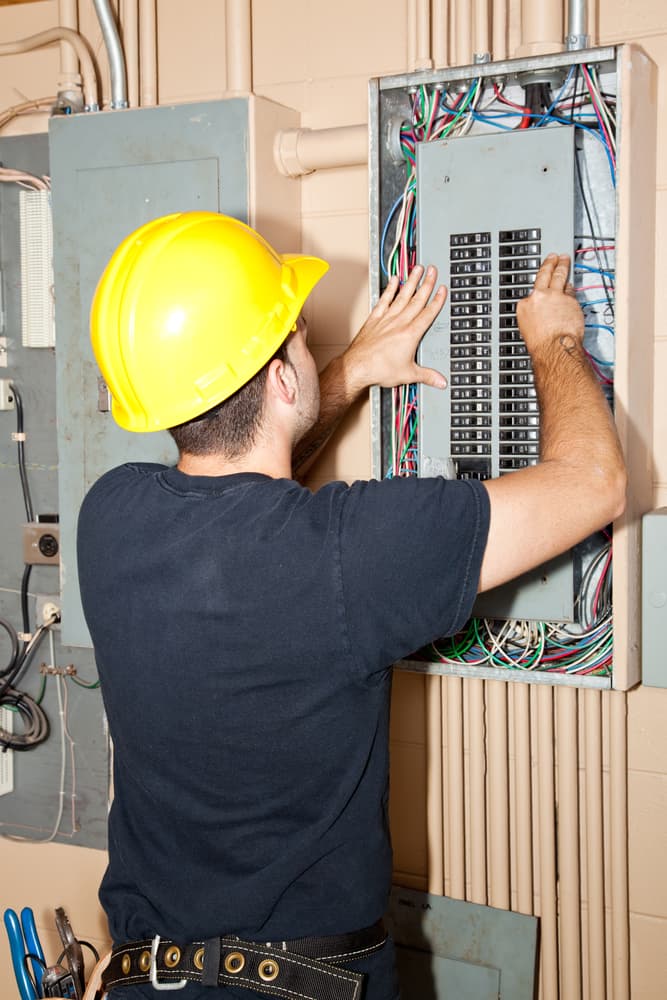 electrician fixing electrical circuit breaker box